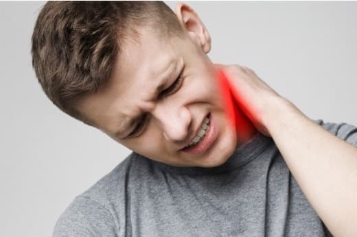 Young adult holding a sore neck